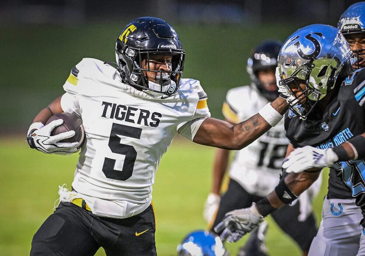Edison's Derion Jones stiff-arms his way past the Clovis North defense on a run down the sideline during their game at Veterans Memorial Stadium in Clovis on Thursday, Aug. 27, 2026.