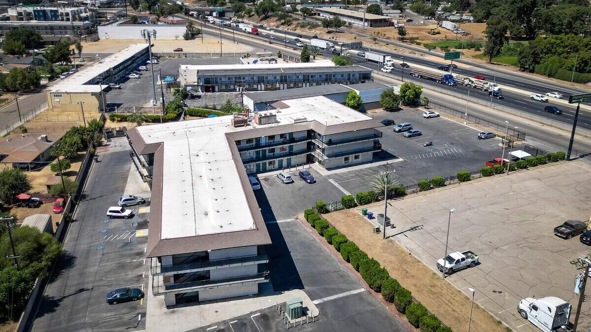 The Valley Inn Motel, center, located on Parkway Drive near Highway 99 and Roeding Park in Fresno, will be converted from a shelter to permanent supportive housing. The City of Fresno has been awarded $32 million for the project. The funding will come from the State of California's Homekey+ Program.