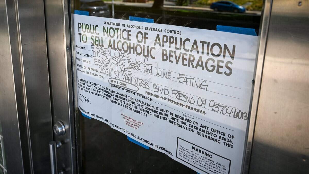 A notice for a liquor license application is posted on the window of a building at 2026 N Van Ness near Fresno High on Monday, Aug. 24, 2026. The neighborhood is known for its tree-lined streets, small business and walkabout traffic.