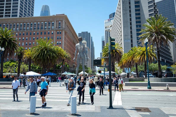 People walk through the Embarcadero neighborhood in San Francisco People walk through the Embarcadero neighborhood in San Francisco