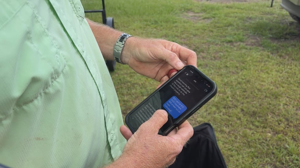 Ron Seals scrolling through text messages between himself and Joseph Brown