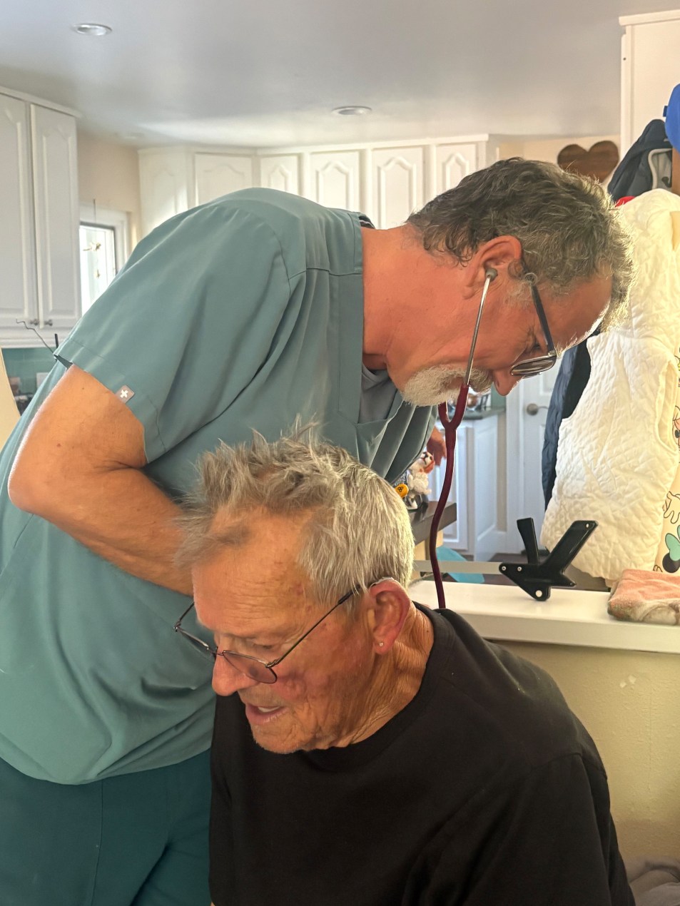 A nurse uses a stethoscope on Mark Vantrease's back.