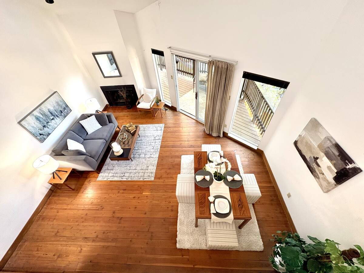 The living room opens toward a spacious balcony, emphasizing the property’s indoor-outdoor connection.