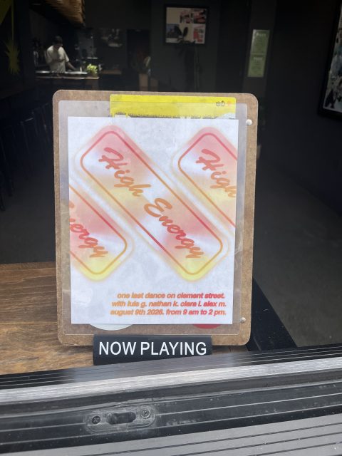 A flyer on a clipboard advertises a dance event called “High Energy” with event details, above a sign that reads “NOW PLAYING.”.