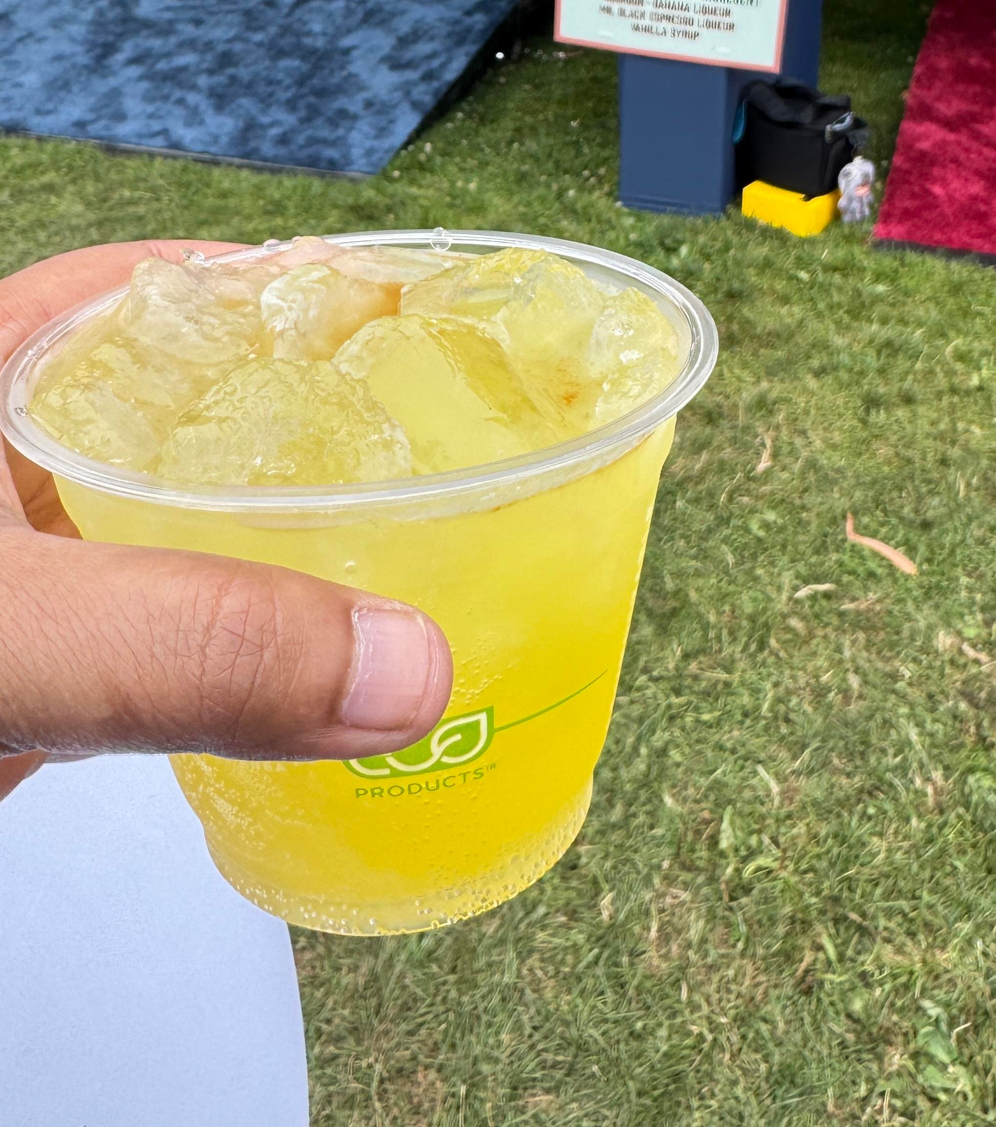 A hand holds a yellow cocktail in San Francisco.