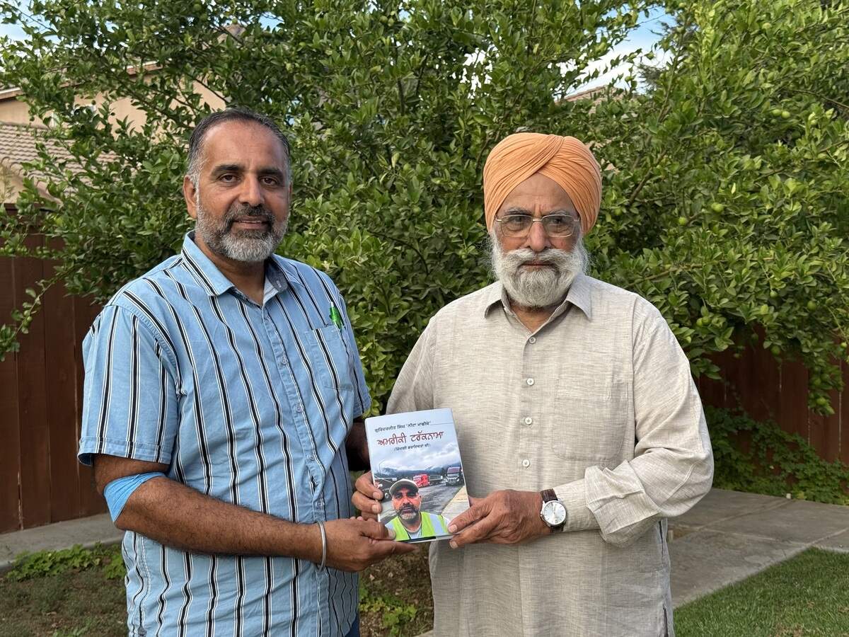 Gurinderjit Singh presents a copy of his newest book to his father, Dalbara Singh Dhaliwal, at their Fresno home on Monday, Aug. 17, 2026.