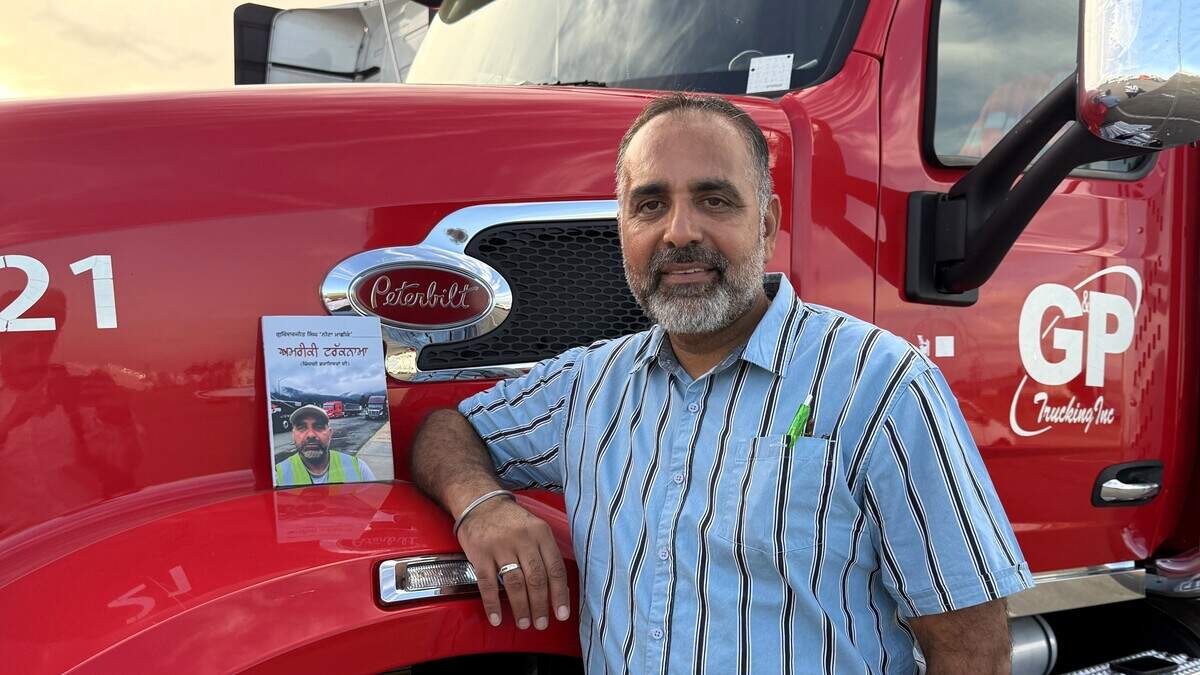 Gurinderjit Singh poses with a copy of his fifth book, “Amereki Trucknama,” propped up on his Peterbilt truck in a yard in Fresno. The book’s name translates to “American Truck Saga.” Gurinderjit Singh poses with a copy of his fifth book, “Amereki Trucknama,” propped up on his Peterbilt truck in a yard in Fresno. The book’s name translates to “American Truck Saga.”