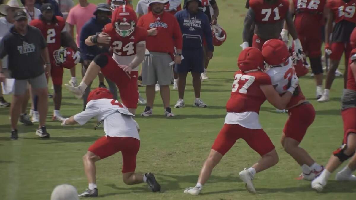 Fresno State RB Julius Gillick hurdles over a teammate during the ‘Midnight Alley’ drill. Fresno State RB Julius Gillick hurdles over a teammate during the ‘Midnight Alley’ drill.