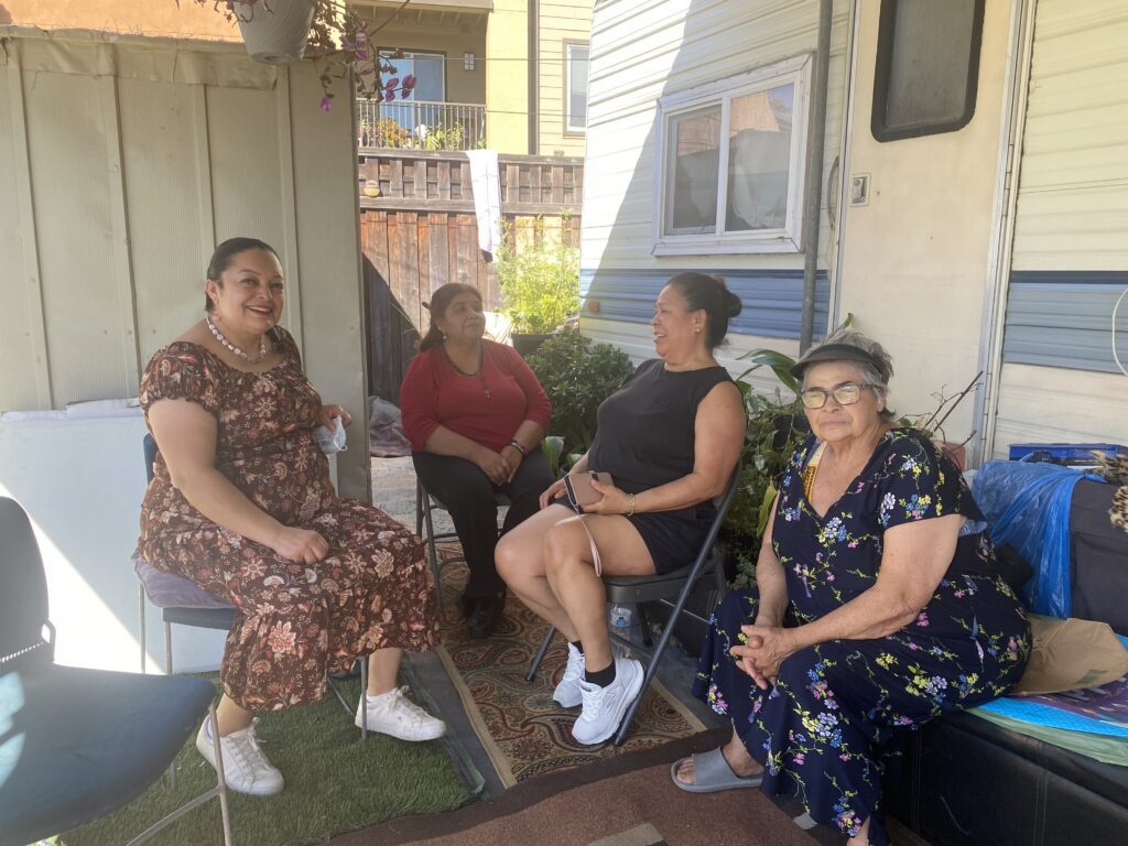 A group of women sitting in chairs at a mobile home park in San Jose, California