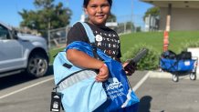 Graciella Miranda shows the light blue backpack she chose for school, August 8, 2026.