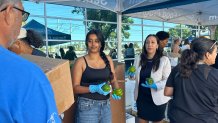 County Supervisor, Paloma Aguirre (white jacket), helped volunteers distribute food, Saturday, to people in danger of losing their Cal Fresh benefits because of federal funding cuts, Chula Vista, Calif., August 8, 2026.