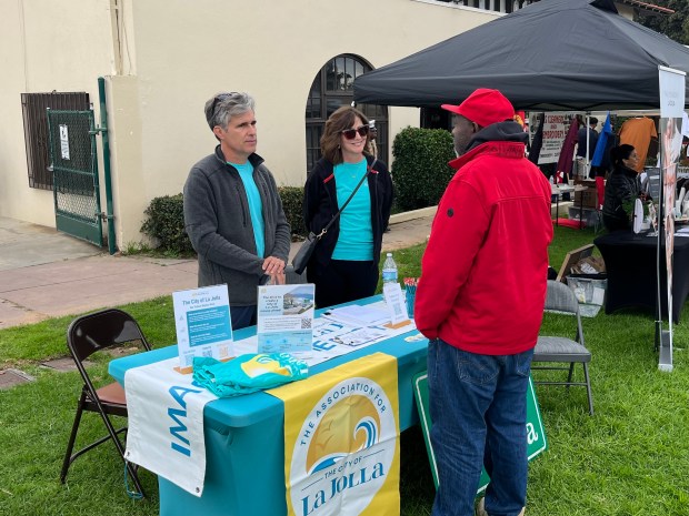 Volunteers for the Association for the City of La Jolla chat with Mira Mesa resident Shane O'Garro at La Jolla Town Council's Multicultural Festival by the Sea last year. (Noah Lyons)