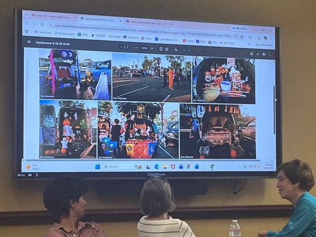 Lizzet Fitz shares photos of last year's Trunk or Treat with La Jolla Traffic & Transportation board meeting attendees on Aug. 18. (Noah Lyons)