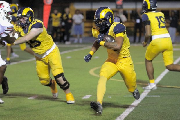 Millikan sophomore Ryan Carter picks up yards against Lakewood at Millikan High School in Long Beach on Friday, Oct. 17, 2025. (Photo by Howard Freshman, Contributing Photographer)