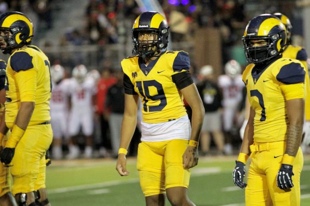 Millikan freshman quarterback Jonah Tuaniga (19) looks toward the sideline for a play call in a game against Lakewood at Millikan High School in Long Beach on Friday, Oct. 17, 2025. (Photo by Howard Freshman, Contributing Photographer)