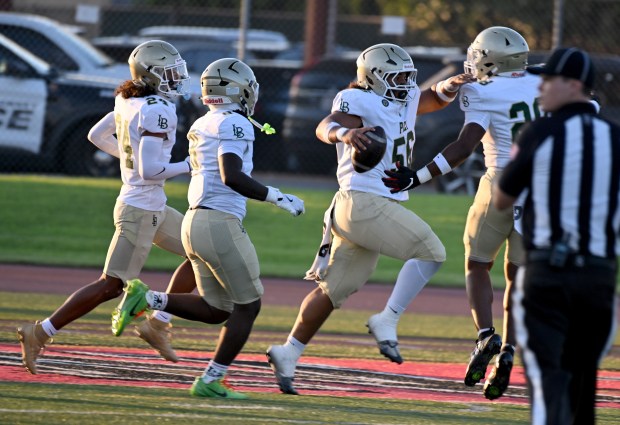 Long Beach Poly's Sammy Timu scores on an interception in the first quarter as Poly defeats Downey in a non-league game and season opener for both teams on Friday August 21, 2026. (Photo by Axel Koester, Contributing Photographer)