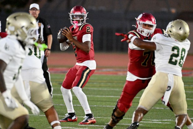 Downey quarterback Chase Watkins (2) looks to pass in a non-league game and season opener against Long Beach Poly on Friday August 21, 2026. (Photo by Axel Koester, Contributing Photographer)