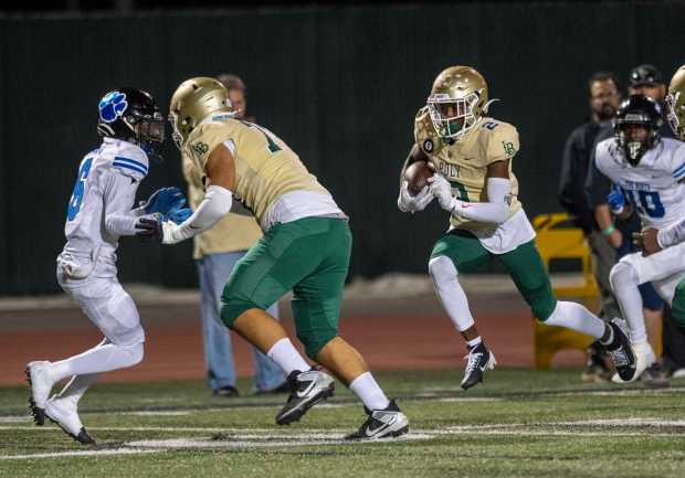 Long Beach Poly's Julius 'Juju' Johnson (2) heads to the end zone during the Moore League football season opener between Long Beach Poly and Long Beach Jordan at Veterans Stadium, Friday, Sept. 20, 2024. (Photo by Michael Goulding, Contributing Photographer)