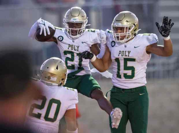 Long Beach Poly's Julius Johnson (21) celebrates his pick-six with Toa Tamasoa (15) during the first half of a Moore League game between Long Beach Poly and Lakewood High at Lakewood High School on September 15, 2023.(Photo by Michael Goulding/Contributing Photographer)