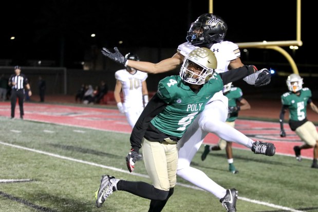 Long Beach Poly's Donte Wright (4) breaks up a pass intended for Northview's Isaiah Lucero in the fourth quarter on Friday, Nov. 8, 2024, in CIF-SS Division 4 playoff action at Veterans Stadium in Long Beach. (Photo by Howard Freshman, Contributing Photographer)