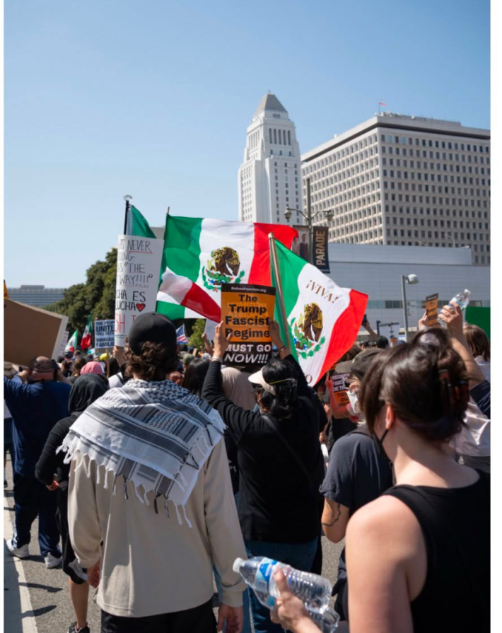 Photograph of protesters marching the streets by Los Angeles City Hall
