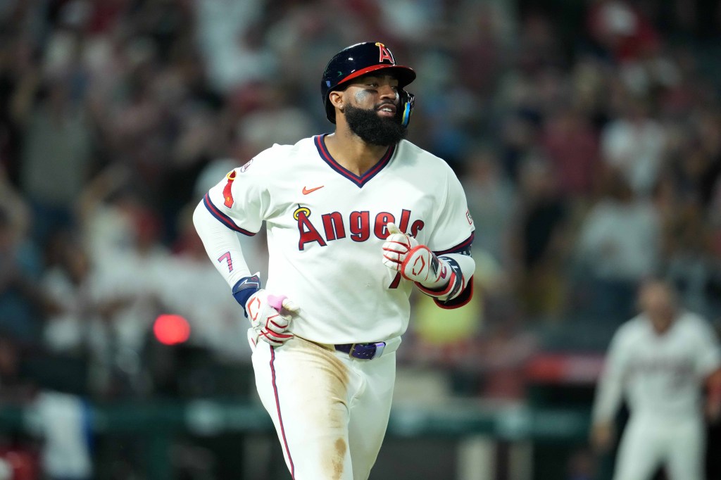 Jo Adell trots around the bases after hitting a home run.