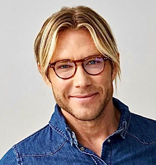 blond man in glasses with light beard staring into the camera