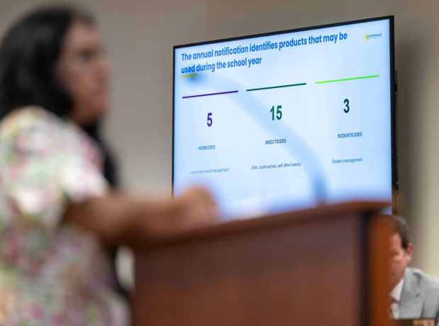 Amanda Quintanilla, a mother and registered nurse, adds her voice to concerns about the use of toxic chemicals for landscaping and pest control purposes on Capistrano Unified School District campuses, while a slide shows the district's historic use of various types of chemicals, during a school board meeting at the district offices in San Juan Capistrano on Thursday, August 13, 2026. (Photo by Jeff Antenore, Orange County Register/SCNG)