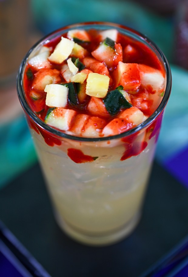 Pineapple-Cucumber Agua Fresca topped with diced cucumber and pineapple drizzled with chamoy and chile-lime seasoning available at Cozy Cone Motel in Cars Land inside California Adventure. Photographed on Friday, August 21, 2026, in Anaheim. (Photo by Jeff Gritchen, Orange County Register/SCNG)