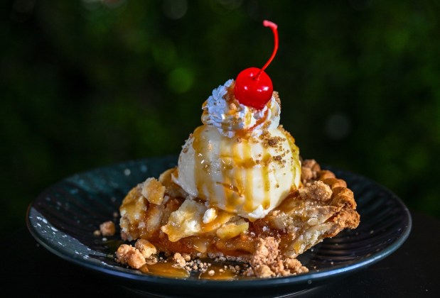 Apple Pie Sundae topped with vanilla ice cream, salted caramel, cinnamon streusel, whipped cream and a cherry available at Golden Horseshoe in Frontierland inside Disneyland. Photographed on Friday, August 21, 2026, in Anaheim. (Photo by Jeff Gritchen, Orange County Register/SCNG)