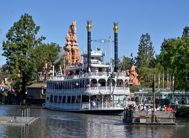 Visitors ride a raft to Pirate's Lair on Tom Sawyer Island as Mark Twain Riverboat leaves its doc on the Rivers of America in Frontierland inside Disneyland in Anaheim, CA, on Tuesday, March 1, 2022. (Photo by Jeff Gritchen, Orange County Register/SCNG)
