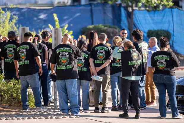 GKN Aerospace employees, wearing matching Teamsters Local 952 union t-shirts, walk into the Garden Grove City Council meeting together at the Garden Grove Community Meeting Center on Tuesday, August 25, 2026. (Photo by Jeff Antenore, Orange County Register/SCNG)