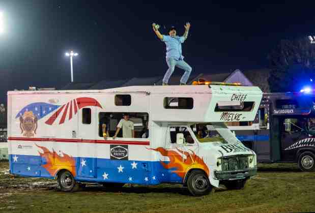 Brea Fire Chief Dan Mielke drives a modified and decorated motorhome while members of his entourage help him make a grand entrance before the start of the Motorhome Madness Demolition Derby at the OC Fair in Costa Mesa on Wednesday, August 5, 2026. (Photo by Jeff Antenore, Orange County Register/SCNG)