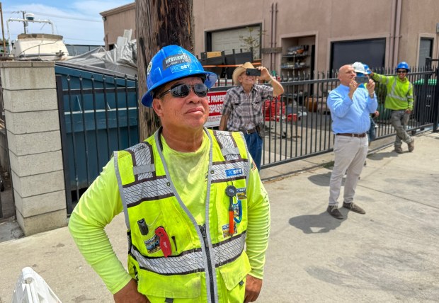 Foreman Luis Alberto Andrade watches as workers lift the last prefab section of a 65-unit apartment complex in Midway City, CA, on Thursday, August 27, 2026. (Photo by Jeff Gritchen, Orange County Register/SCNG)
