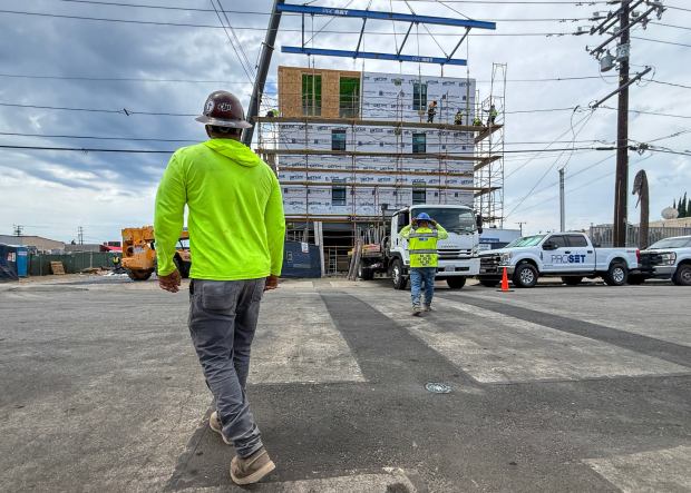 Workers lift the last prefab section of a 65-unit apartment complex in Midway City, CA, on Thursday, August 27, 2026. (Photo by Jeff Gritchen, Orange County Register/SCNG)