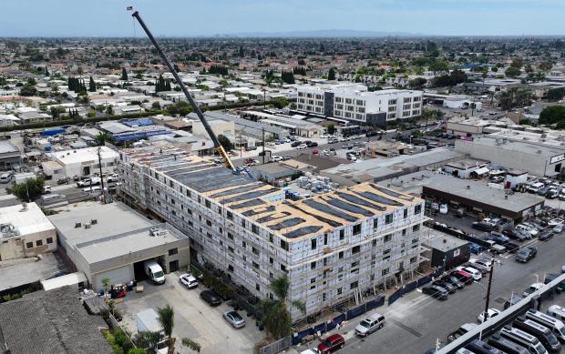 Workers lift the last prefab section of a 65-unit apartment complex in Midway City, CA, on Thursday, August 27, 2026. (Photo by Jeff Gritchen, Orange County Register/SCNG)