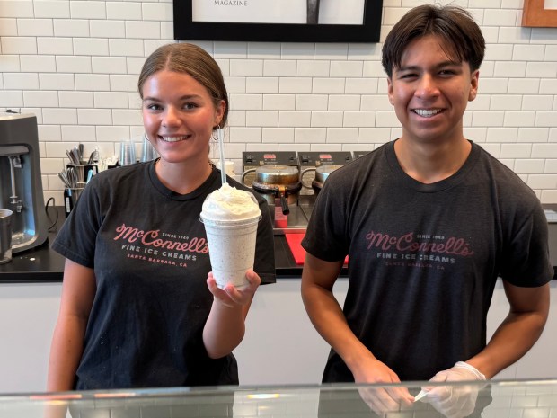 Two employees pose with the Coooookie Shake at McConnell's Ice Cream in San Juan Capistrano. (Photo by Brock Keeling, Orange County Register/SCNG)
