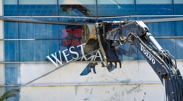 Bill Shopoff operates an excavator as he tears down an entrance to Westminster Mall in Westminster, CA, on Wednesday, April 15, 2026. Shopoff, President and CEO of Shopoff Realty Investments, said he recognized the responsibility developing a legacy site, "You're not just replacing buildings. You're stewarding a piece of community history while shaping what comes next.". The 83-acre site is slated to become Bolsa Pacific, a mixed-use development by Shopoff Realty that promises open space, retail and approximately 2,250 housing units including a new Target. (Photo by Jeff Gritchen, Orange County Register/SCNG)