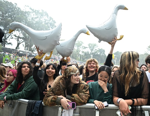 Fans hold geese balloons as they wait for GEESE to perform on the Sutro stage during Outside Lands in San Francisco on Aug. 7, 2026. (Chris Riley/Times-Herald)