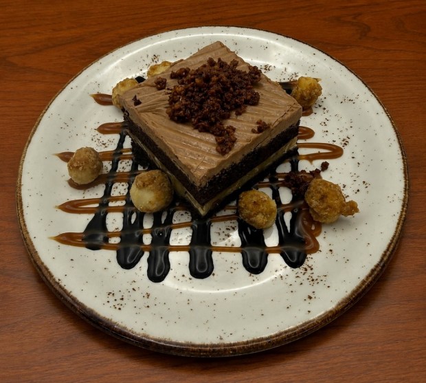 Hawaiian chocolate cake has a macadamia-coconut filling, chocolate buttercream, caramelized coconut crumb, macadamia nuts and salted caramel. (Courtesy of Catamaran Resort Hotel and Spa)