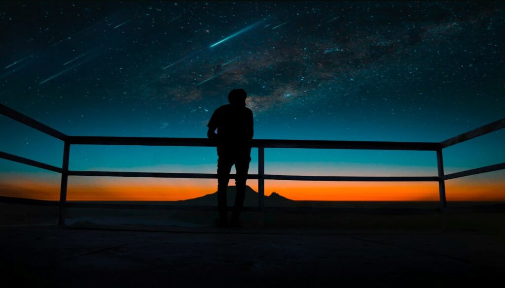 A person watches a meteor shower