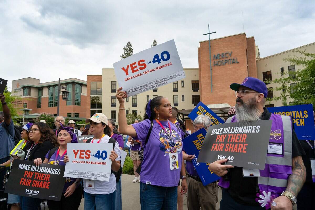 Hundreds of frontline healthcare workers from across California rally outside Dignity Health Mercy General Hospital on Friday in support of Proposition 40, which would levy a one-time tax on California billionaires.