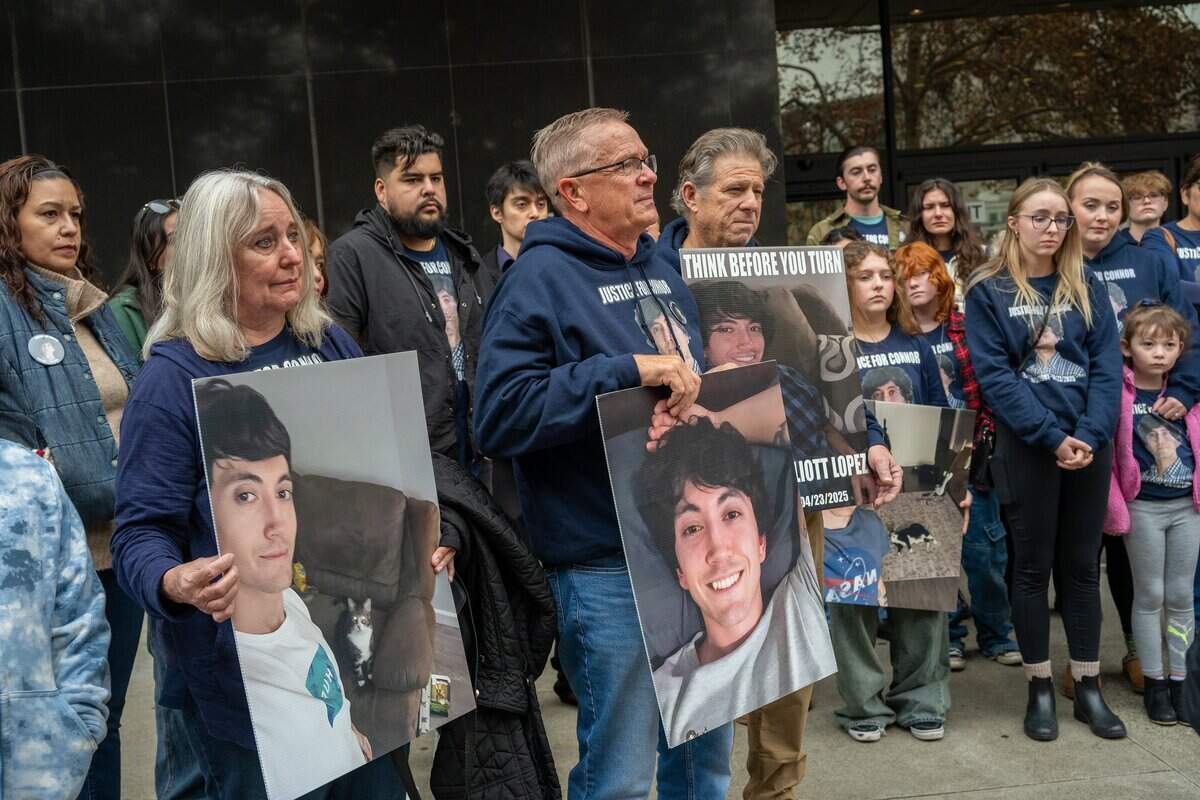 Family members, including Connor Lopez’s grandmother Christine Clinkenbeard, hold signs outside Sacramento Superior Court in hopes of finding some closure during the arraignment of Harjit Kaur on Dec. 15. Kaur did not appear in court. Two of his younger siblings — Julia and Ava Lyman — stand at center behind a photo of his beloved but ill-tempered cat, Benny.