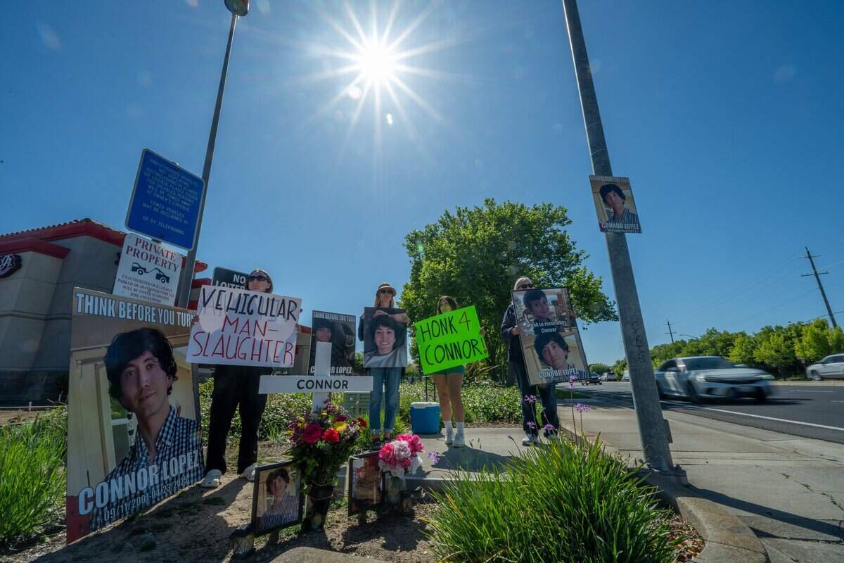 Allison Lyman, left, holds a vehicular manslaughter sign on April 29 near the intersection in Elk Grove where her son, Connor Lopez, was struck by a motorist and killed while riding his motorcycle in 2025. Lyman has spent every Wednesday between 3 p.m. and 4 p.m. at the intersection with relatives since her son was struck and killed. The only Wednesday she missed was New Year’s Eve.