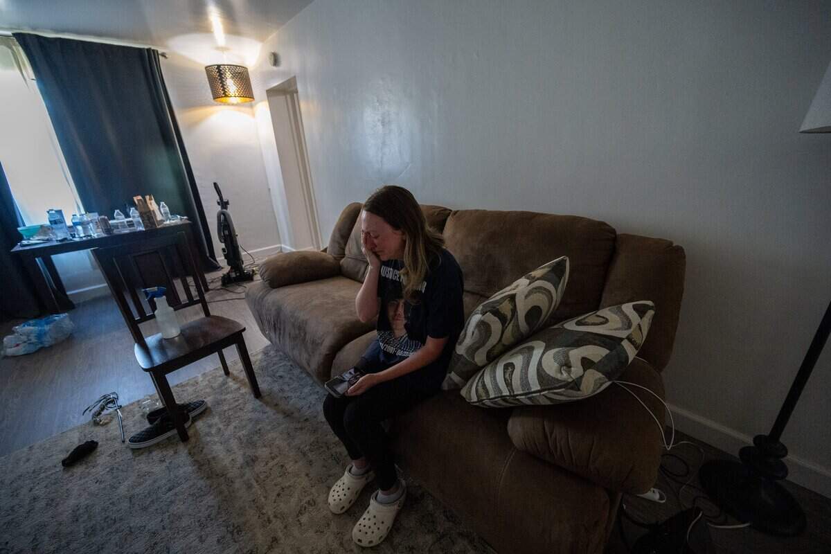 Allison Lyman listens to her late son Connor Lopez’s piano music on her mobile phone on June 17, while visiting his apartment near Sacramento City College, where he was a student. Lopez was a piano teacher who hoped to attend law school. She has kept the apartment and the light on since his death in April 2025.