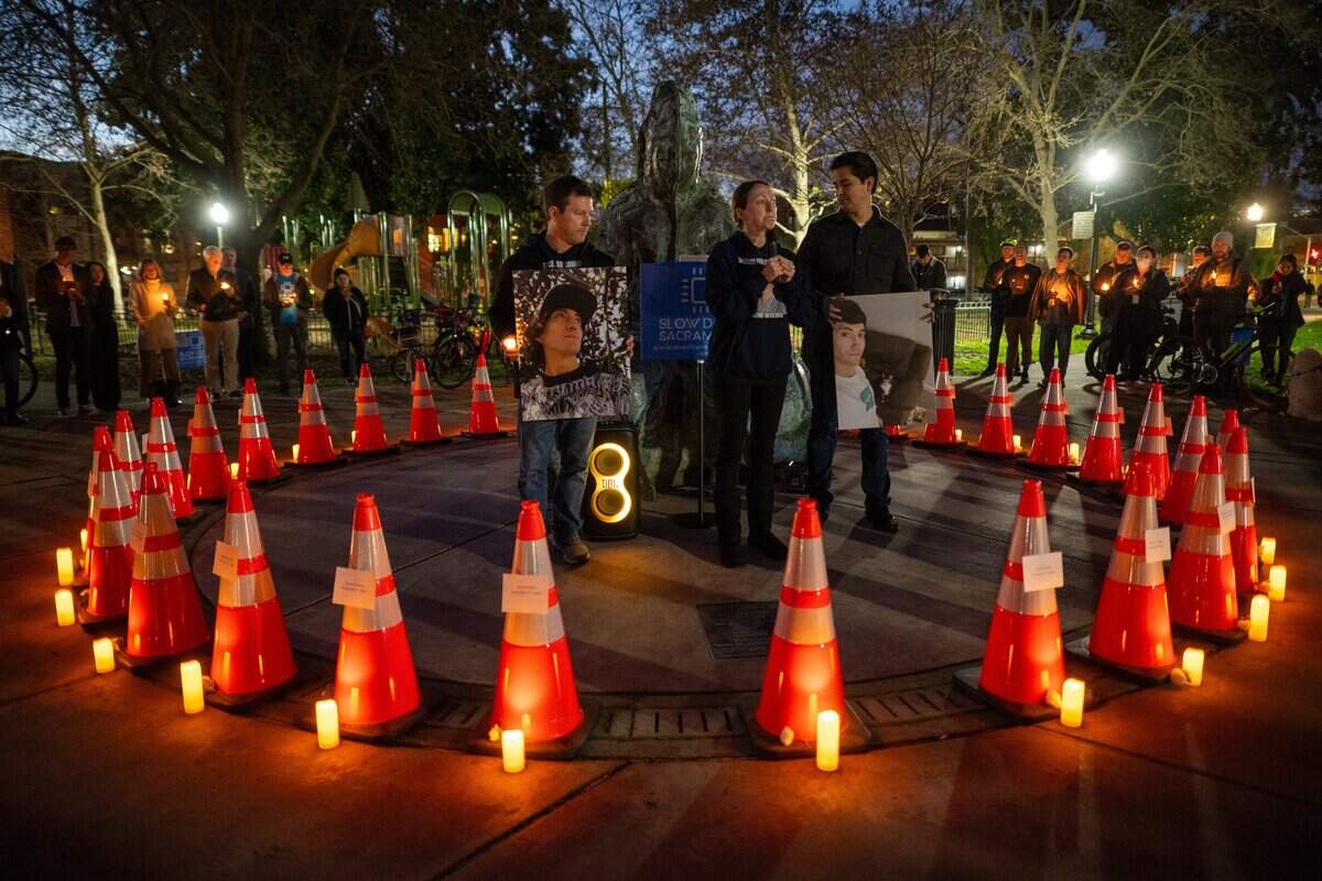 Allison Lyman, center, speaks about the impact of her son Connor Lopez’s death alongside her husband, John Lyman, left, who holds a photo of Lopez, during the second annual vigil for lives lost to vehicular violence within Sacramento city limits at Fremont Park in downtown on Jan. 7. The traffic cones represent victims killed in traffic collisions.