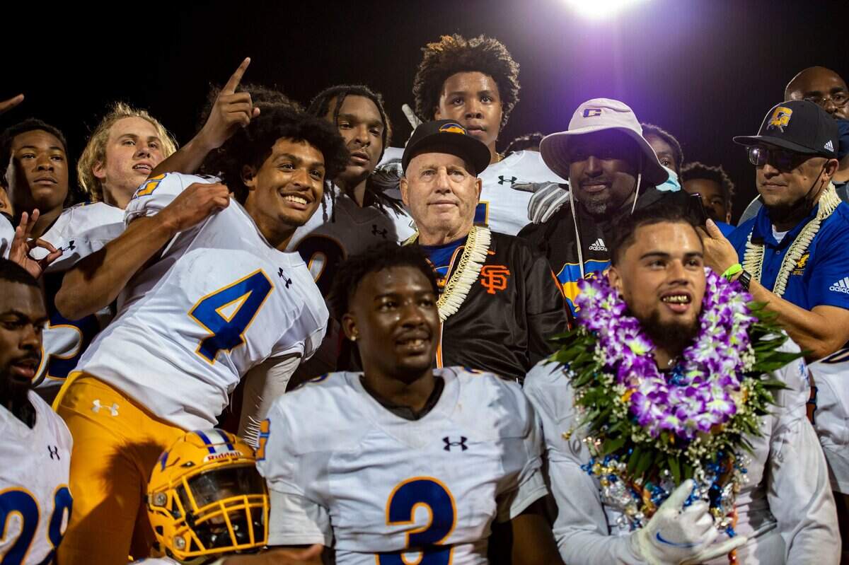 Grant Pacers coach Mike Alberghini poses with his team after winning the final game of a COVID-shifted season in April 2021. It was Alberghini’s 282nd win.