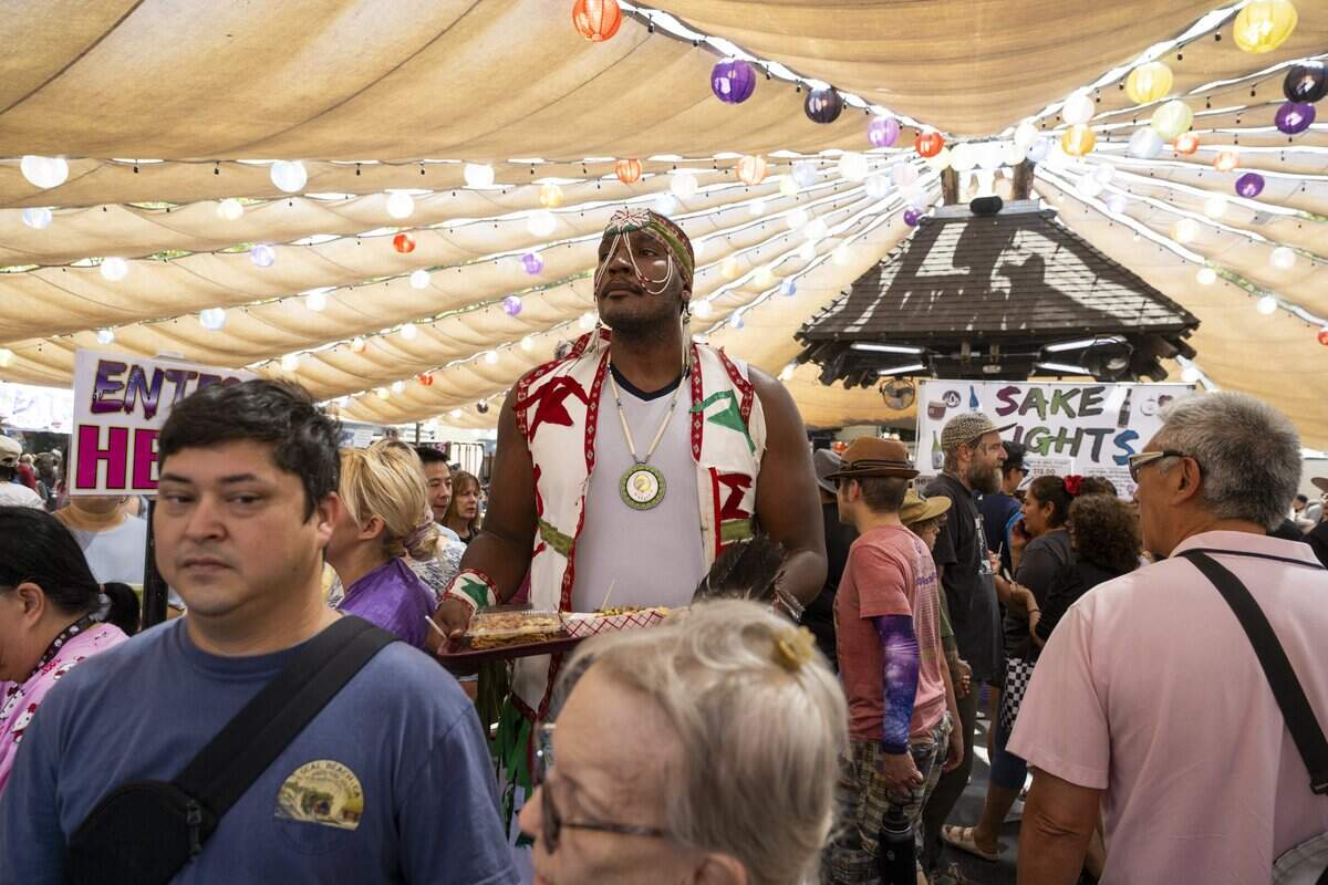 Native American dancer Shämir Griffin takes a break from the Sacramento PowWow to show his support for the 80th annual Japanese Food & Cultural Bazaar at the Buddhist Church of Sacramento on Saturday.