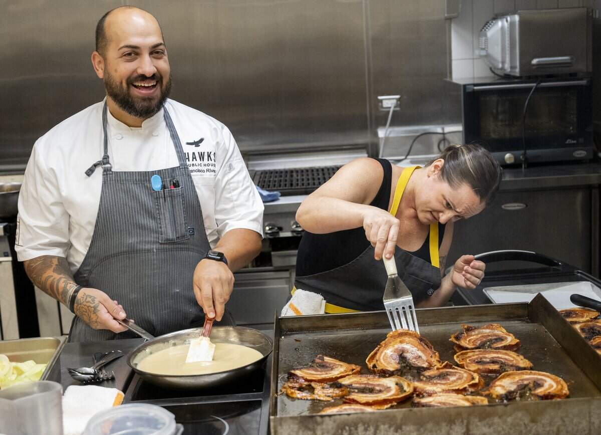 Lead chefs Francisco Rivera, of Hawks Public House, and Kate Sutherland, of Waterboy, joke with each other while preparing the dishes they will serve at the upcoming Tower Bridge Dinner during a preview showcase at the Central Kitchen in Sacramento on Monday.