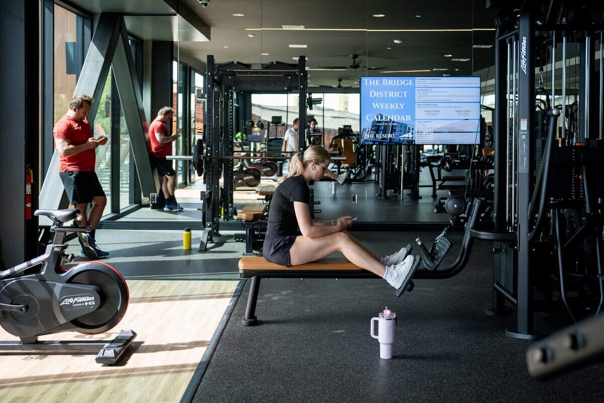 Residents work out in the fitness center at The Resort in West Sacramento’s Bridge District on Thursday, Aug. 20, 2026.
